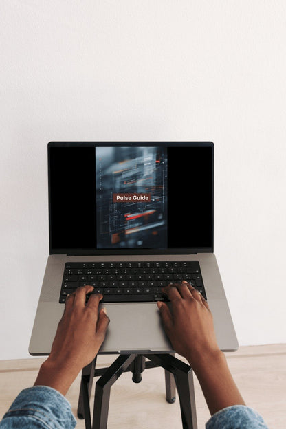 Person using a laptop with a screen displaying 'Pulse Guide' on a white background